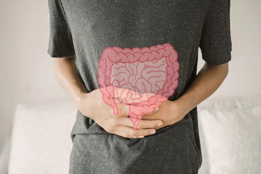 A man grimacing in pain, clutching his stomach due to a severe digestive issue known as leaky gut syndrome.