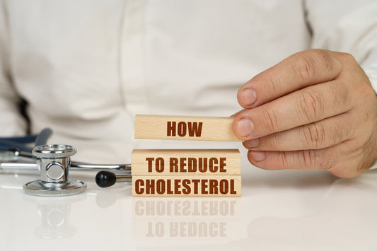 picture with fingers holding it displaying how to lower cholesterol