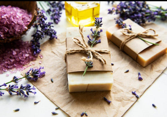 picture showing two natural soap bars on a brown paper with sprinkled flowers