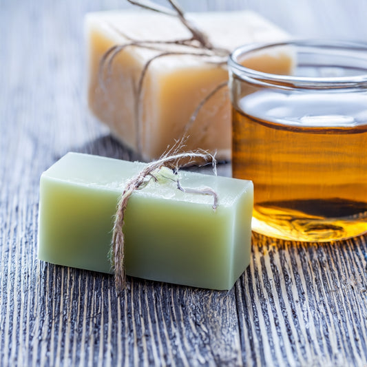 Natural soap and honey on wooden table, ideal for sensitive skin.