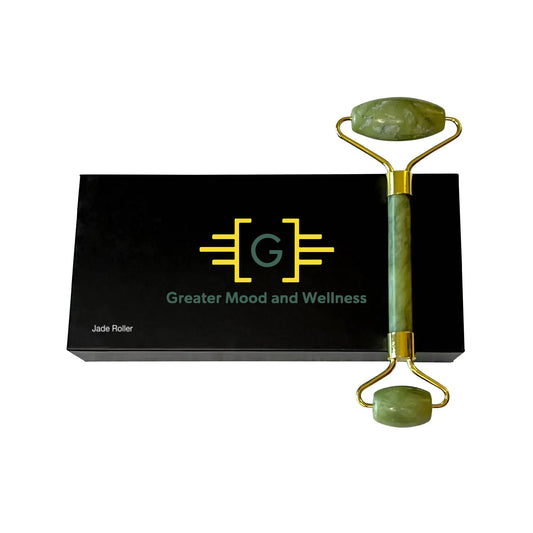 A box containing a green jade roller, a stone massager used for relaxation and skincare.
