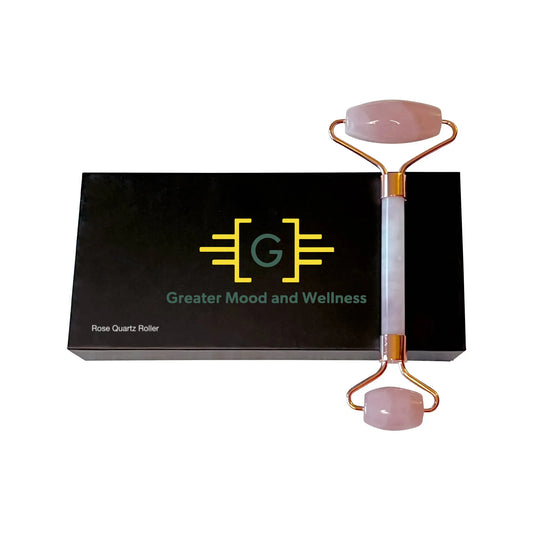 Black box with rose quartz roller laying on top