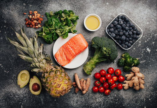 Picture of foods like berries, leafy greens, salmon, and olive oil, promoting an anti-inflammatory diet.