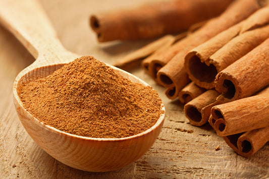 Wooden Spoon with Cinnamon spice, commonly used in various recipes for its distinct flavor and aroma.