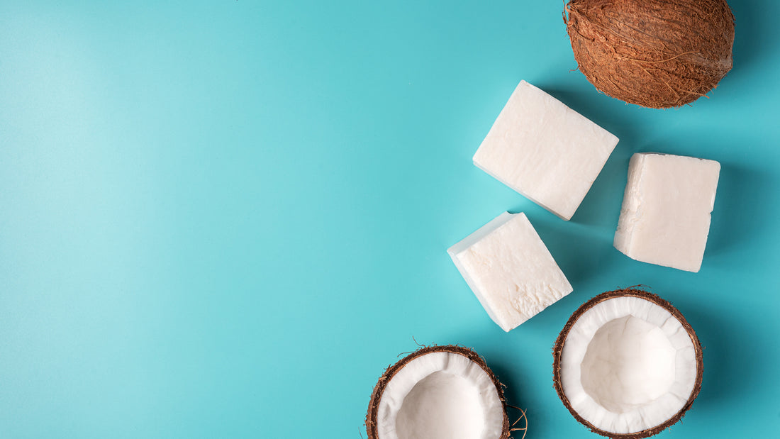 Coconut handmade soap and coco on blue background.