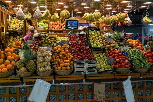 A diverse assortment of fruits and vegetables displayed at a fruit and vegetable stand. The Valencia Diet.