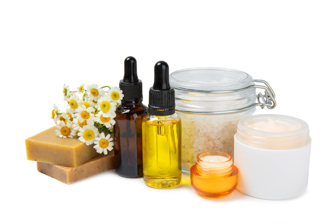 Various organic skincare products and essential oils displayed on a white background.