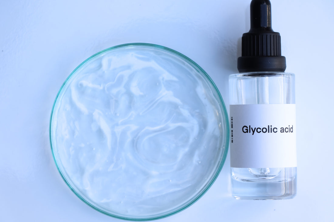 A bottle of glycolic acid and a glass bowl, used for achieving glowing skin.