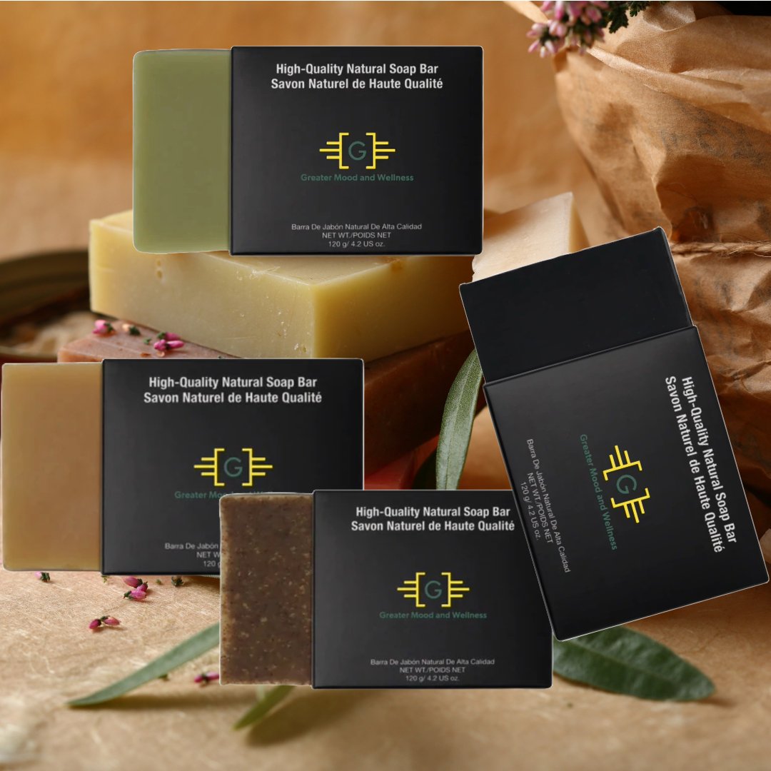 variety of charcoal turmeric aloe vera and apricot soap bars engraved with the word  Greater Mood  in a basket  in bathroom
