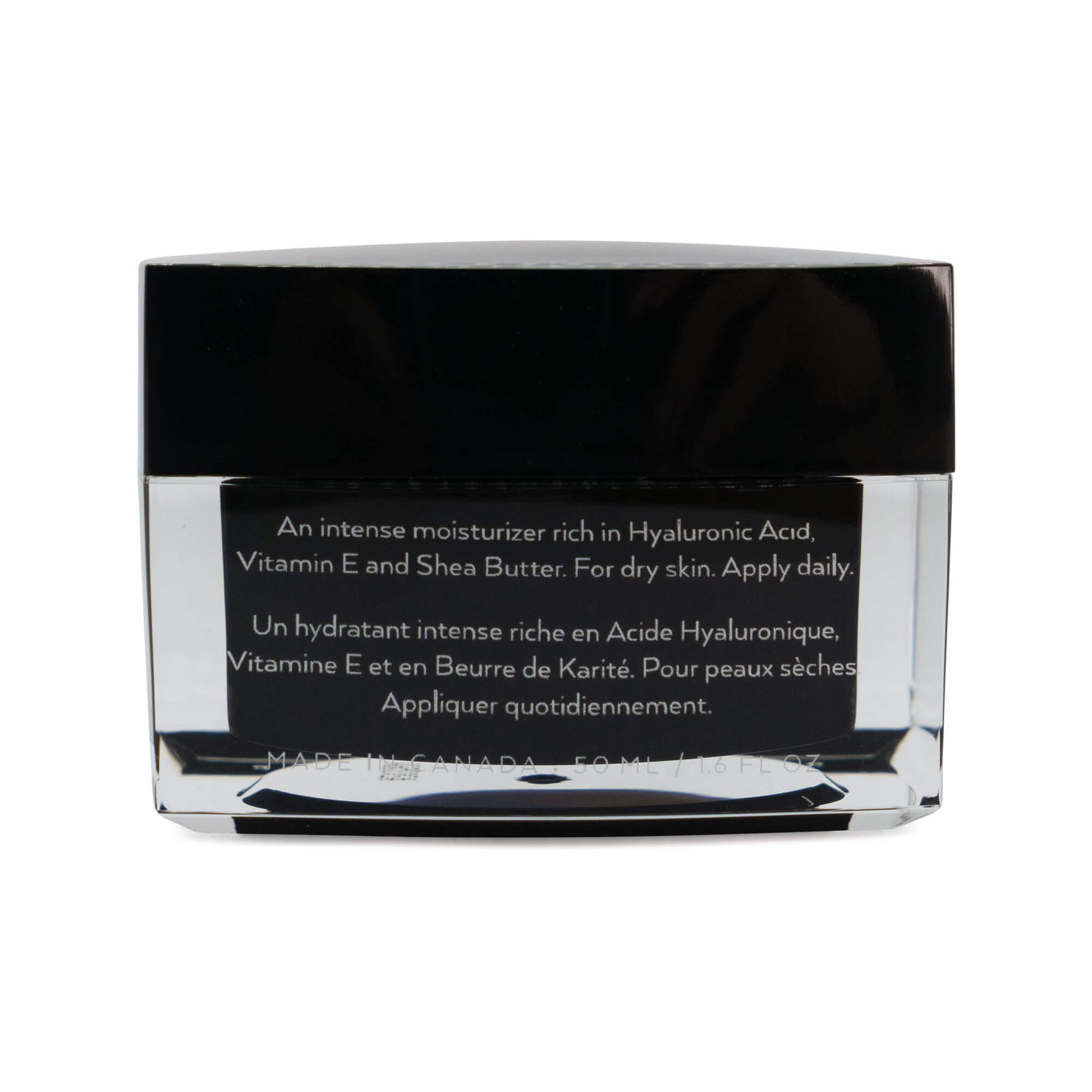 A jar of hyaluronic moisturizer, containing black and white cream, placed on a white surface.