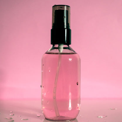 A small bottle of oil control setting spray with black spray top