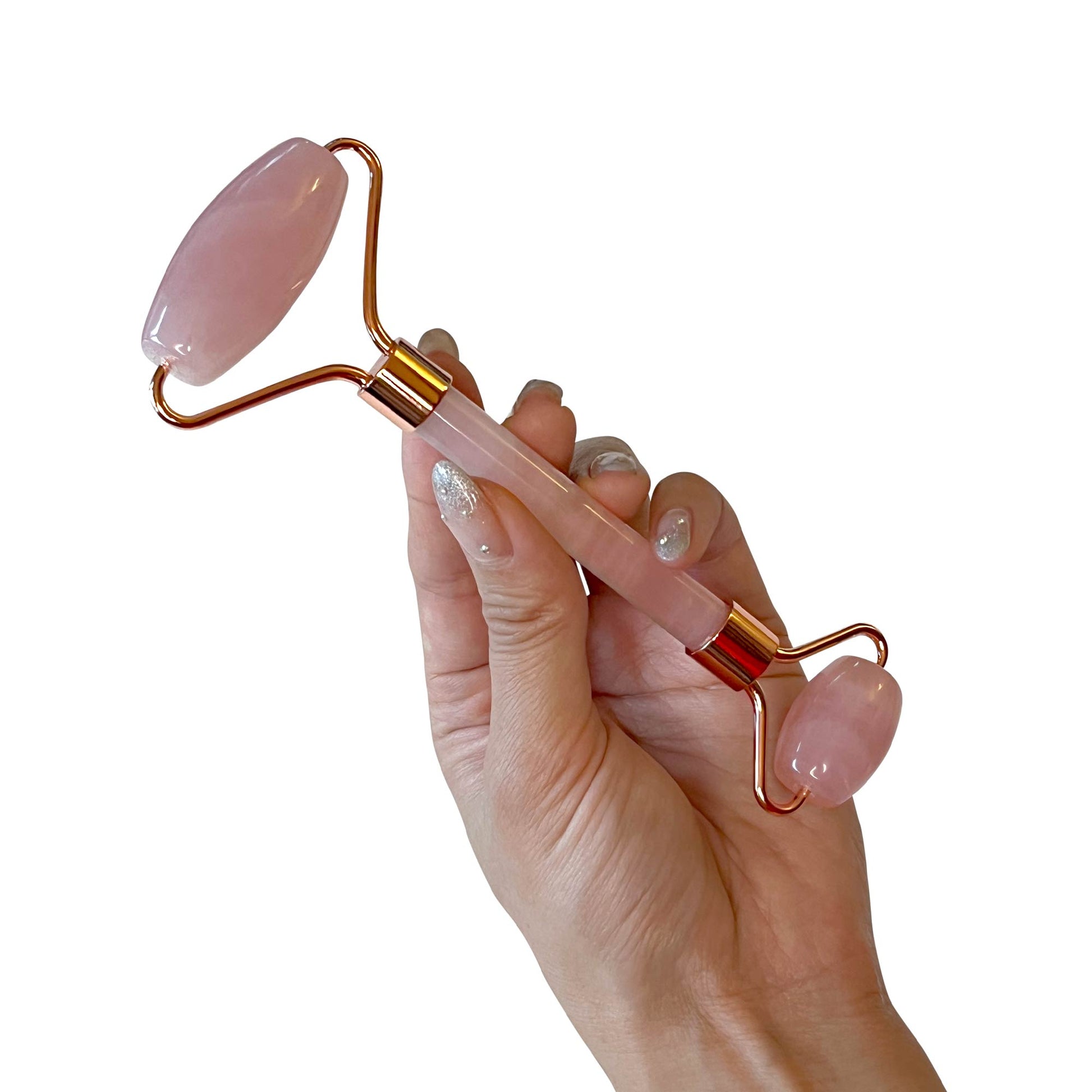 Hand holding a rose quartz roller